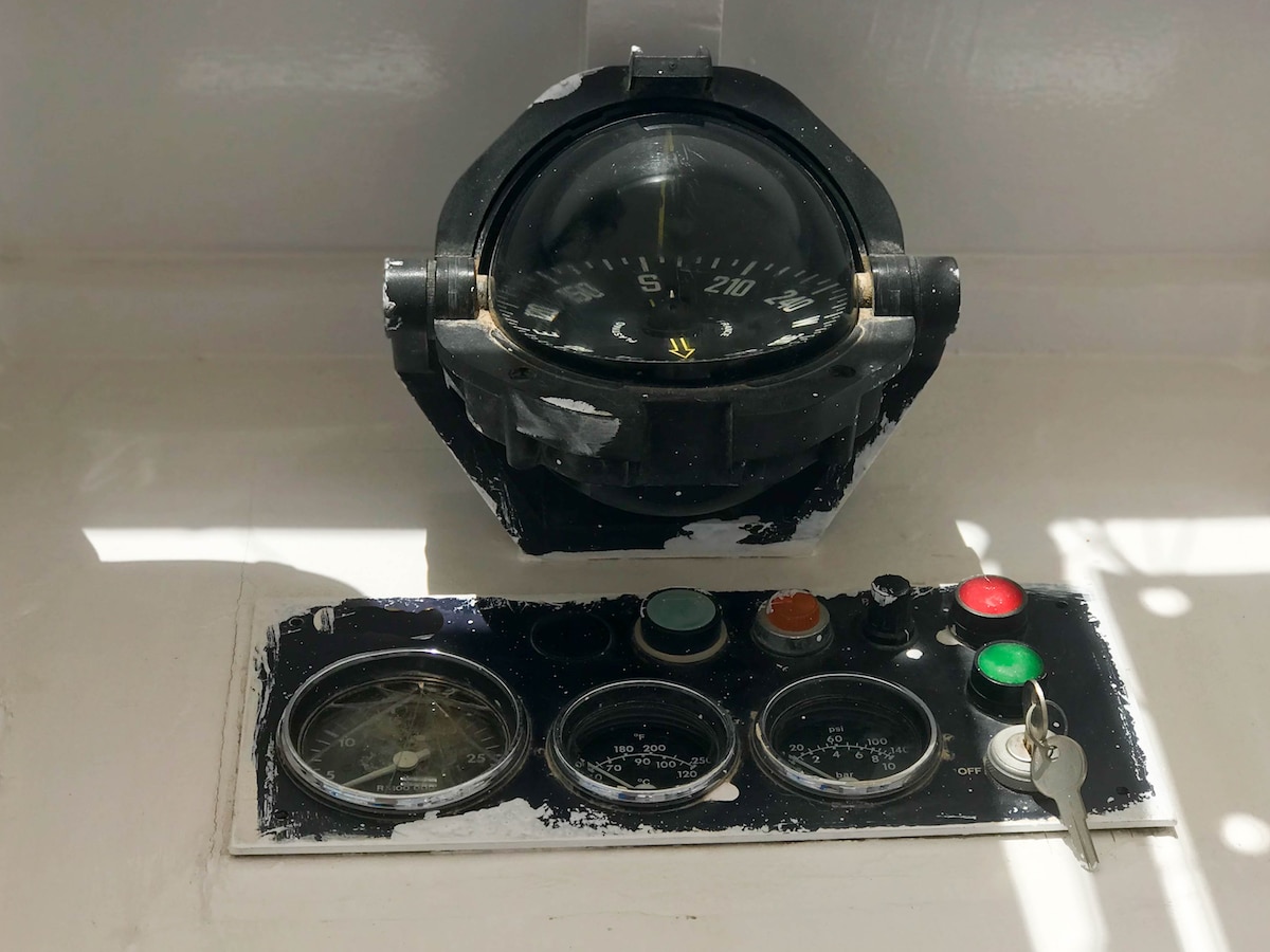 Instrument panel on a boat, ship, maritime transport with a compass, a tachometer, a speedometer, an ignition key and buttons