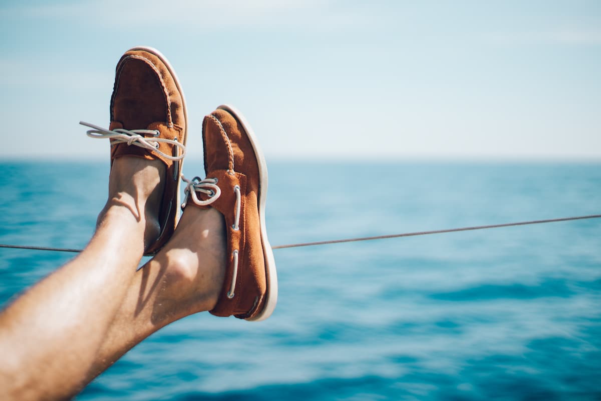 Photo of man legs on the yacht and wearing boat
