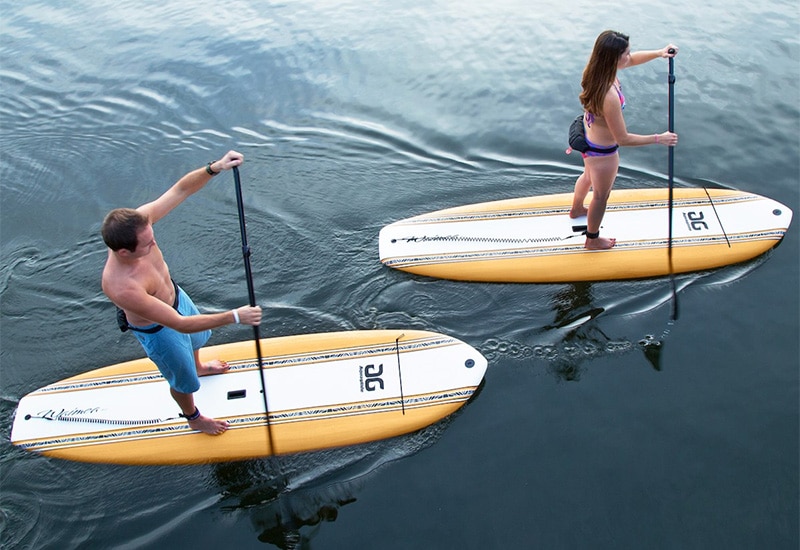 Couple using soft top paddleboards