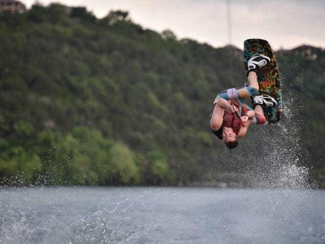 Guy flipping on wakeboard