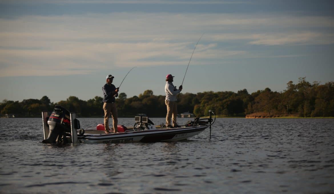 two men fishing on a bass boat