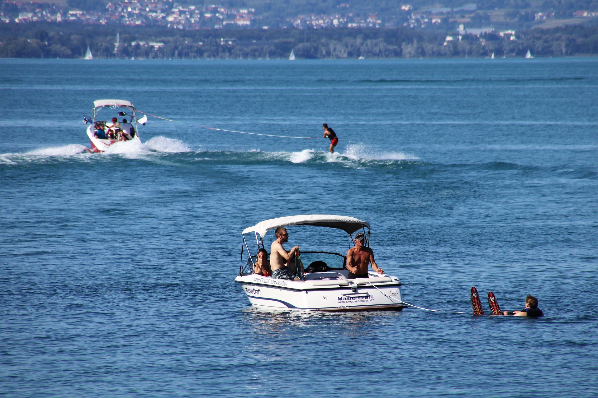 a boat pulling some skiiers
