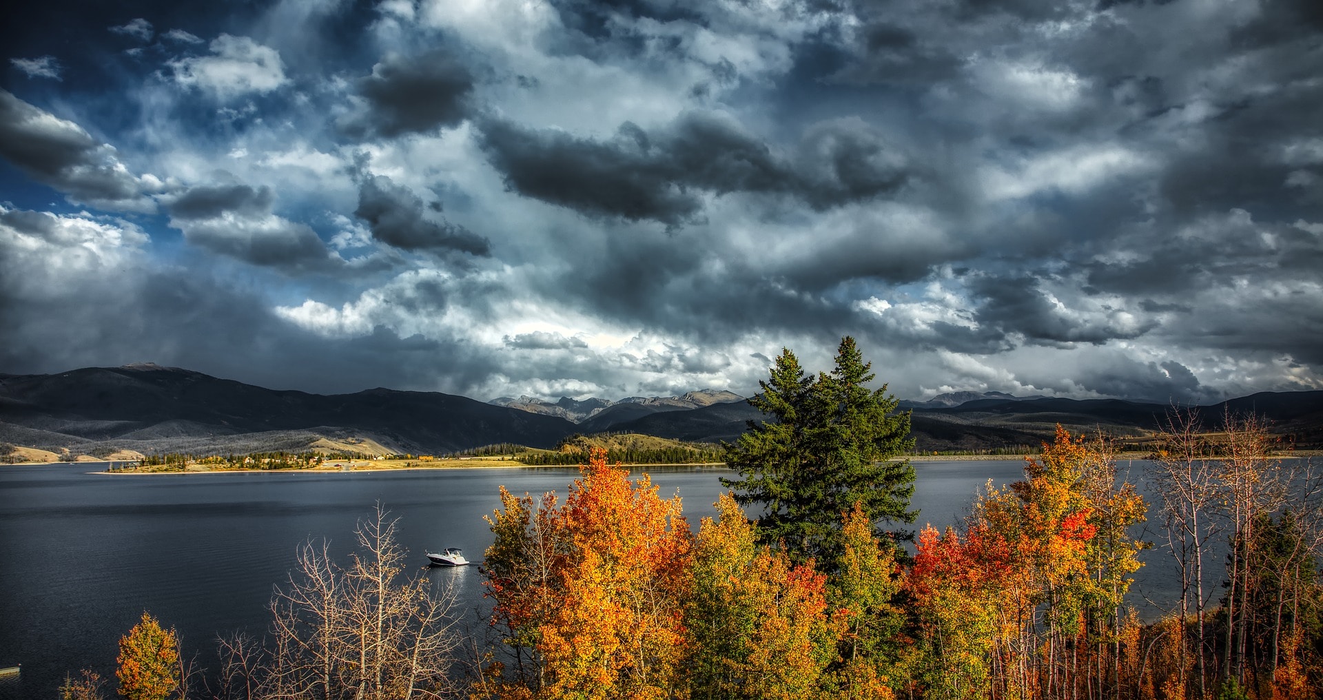 fall storm approaching a boater on a lake
