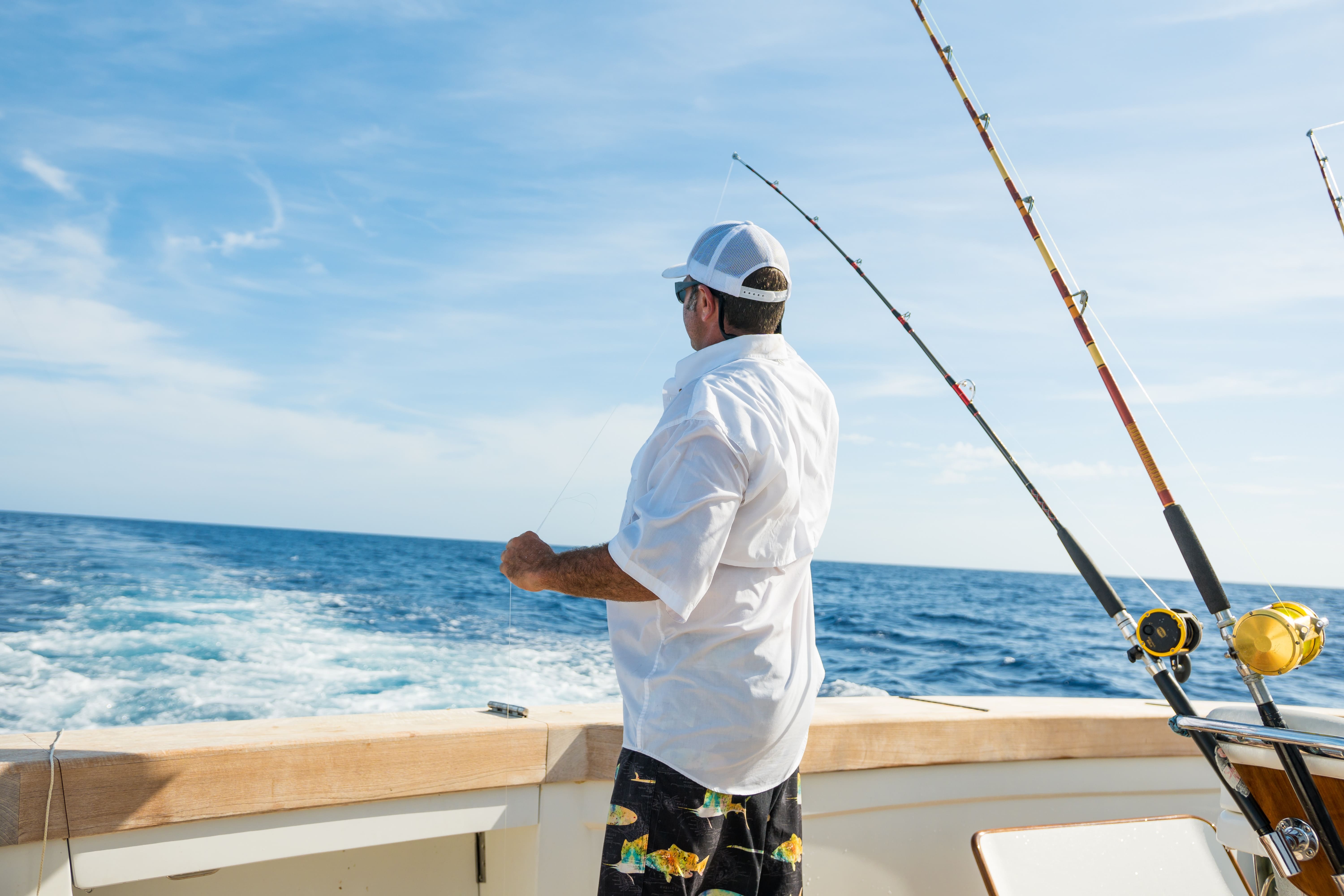 man catching grouper while deep sea fishing during a winter fishing trip