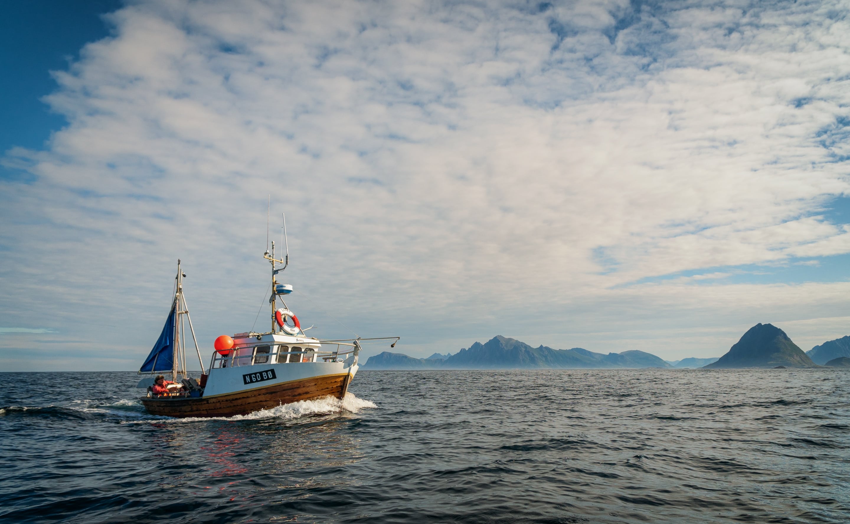 Charter fishing boat out to sea during a winter fishing trip