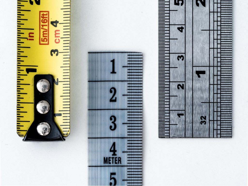 Yellow and silver measuring tapes and rulers