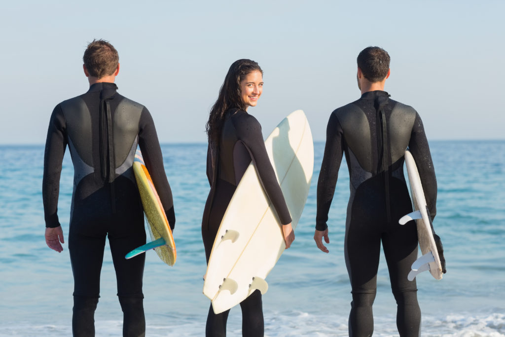 Three Surfers in Wetsuits